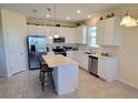Modern kitchen with stainless steel appliances and an island at 648 Daring Dr, Davenport, FL 33837