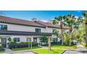 Exterior of home showing the carport, landscaping, and walkway at 660 Killarney Bay Ct # 6, Winter Park, FL 32789