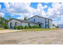 Two-story house exterior, showcasing a modern design and landscaping at 711 Cypress Ave, Orange City, FL 32763