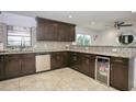 Spacious kitchen with dark cabinetry, granite counters, and stainless steel appliances at 711 Cypress Ave, Orange City, FL 32763