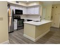 Modern kitchen with stainless steel appliances and white cabinets at 7220 Westpointe Blvd # 1421, Orlando, FL 32835