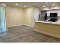 Open kitchen with island, stainless steel appliances, and white cabinets at 7220 Westpointe Blvd # 1421, Orlando, FL 32835