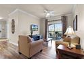 Bright living room with balcony access and hardwood floors at 8020 Tuscany Way # 6401, Davenport, FL 33896