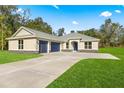 Newly constructed home with a three-car garage and spacious yard at Tbd Marion Oaks Ln, Ocala, FL 34473
