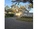 Fenced-in backyard with a basketball hoop and shed, perfect for outdoor activities and storage at 1026 Lake Jessamine Dr, Orlando, FL 32839