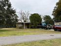 Ranch style home with a large front yard and driveway at 110 Country Club Cir, Sanford, FL 32771