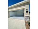 New two-car garage with painted floor at 1112 Saguaro St, Haines City, FL 33844