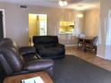 Cozy living room with an open view to the kitchen and dining area, furnished with a leather sofa set at 1313 S Pine Ridge Cir # C1, Sanford, FL 32773