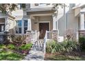 Townhome front entrance with stone accents and white railing at 15407 Blackbead St, Winter Garden, FL 34787