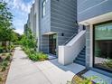 Side view of townhouses, showing walkway and landscaping at 1762 Mondrian Cir, Winter Park, FL 32789