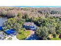 Stunning home on a sprawling, wooded lot with lush landscaping and a brick driveway near waterfront at 2395 Windward Cv, Kissimmee, FL 34746
