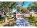 House exterior showcasing a well-maintained yard and tree-lined street at 3713 Doune Way, Clermont, FL 34711