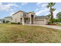 Two-story house with a large front yard and attached garage at 5791 Covington Cove Way, Orlando, FL 32829