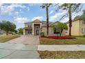 Two-story house with a paved driveway and landscaping at 5791 Covington Cove Way, Orlando, FL 32829