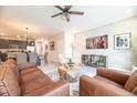 Inviting living room featuring a brick accent wall, modern decor, and stylish furnishings at 7925 Putting Green Way, Reunion, FL 34747