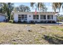 Exterior view of a clean, well-maintained home featuring abundant front yard space at 814 S Lakeshore Blvd, Lake Wales, FL 33853
