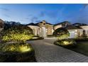 Stunning home with a brick paver driveway and beautifully lit landscaping at 8148 Tibet Butler Dr, Windermere, FL 34786