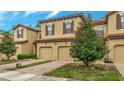 Charming two-story townhome with a terracotta roof, attached garage, and landscaped front yard at 8189 Roseville Rd, Davenport, FL 33896