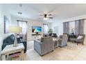 Spacious living room featuring ample seating and a large TV at 9024 Shadow Mountain St, Davenport, FL 33896