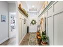Bright entryway with wainscoting, bench, and decorative wreath at 9459 Jaywood Rd, Winter Garden, FL 34787