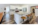 Kitchen with white cabinets, stainless steel appliances, large island, and seating at 10010 Crenshaw Cir, Clermont, FL 34711