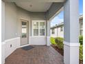 Covered front porch with brick pavers and access to the front door at 1069 Avery Meadows Way, Deland, FL 32724
