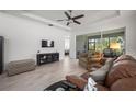 Spacious living room with hardwood floors, comfortable seating, and access to the back porch at 1069 Avery Meadows Way, Deland, FL 32724