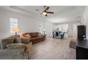 Open living room and dining area with light hardwood floors and neutral colors at 1069 Avery Meadows Way, Deland, FL 32724