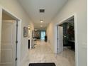 Bright hallway with tile floors, leading to living areas and bedrooms at 1178 Drop Ln, Kissimmee, FL 34747