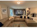 Spacious living room with large sectional sofa, dining area, and view to backyard at 1178 Drop Ln, Kissimmee, FL 34747