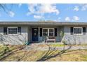 Inviting front porch with a blue door and a wooden bench at 1201 Carol Ave, Auburndale, FL 33823