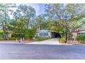 Light blue manufactured home with a long driveway and street view at 151 E Plantation Blvd, Lake Mary, FL 32746