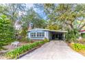 Quaint light blue manufactured home nestled in a wooded area with a flag at 151 E Plantation Blvd, Lake Mary, FL 32746