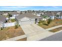 Single Gathering home with a three car garage and fenced backyard at 15267 Aquarius Way, Mascotte, FL 34753