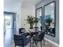 Small dining area with a glass table and four blue chairs at 1545 Isleta Loop, Kissimmee, FL 34741
