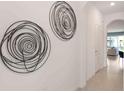 Hallway with two circular metal wall sculptures at 1545 Isleta Loop, Kissimmee, FL 34741