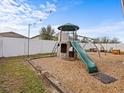 Backyard featuring a play structure and ample space for outdoor activities at 1882 Rustic Falls Dr, Kissimmee, FL 34744