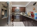 Dark wood cabinets, granite countertops, and stainless steel appliances at 245 Scottsdale Sq # 245, Winter Park, FL 32792