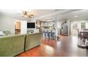 Open-concept living room flowing into kitchen, featuring hardwood floors and modern finishes at 24908 County Road 561, Astatula, FL 34705