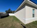 Side yard view of the house with a white fence at 2621 Sw 152Nd Ln, Ocala, FL 34473