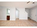 Bright living room features neutral paint, tile flooring, and a small wet bar at 3208 Oak Lawn Pl # 218, Winter Park, FL 32792