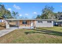 A single story home with a large front yard, carport and brick accents at 3309 Drake Dr, Orlando, FL 32810