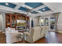 Spacious living room with a custom entertainment center, fireplace, and a unique coffered ceiling at 442 Treviso Dr, Poinciana, FL 34759