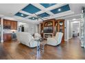 Open concept living space with hardwood floors, a fireplace, custom cabinets, and elegant decor at 442 Treviso Dr, Poinciana, FL 34759