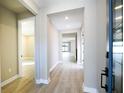 Bright hallway features wood-look floors and neutral paint, illuminated with recessed lighting for a modern feel at 4425 Lions Gate Ave, Clermont, FL 34711