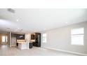 Spacious open floor plan with bright kitchen featuring an island, modern fixtures, and stainless steel appliances at 4425 Lions Gate Ave, Clermont, FL 34711