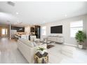 Open-concept living room featuring a modern kitchen with an island, ample seating, and a light-filled interior at 4425 Lions Gate Ave, Clermont, FL 34711
