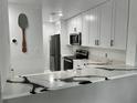 Modern kitchen with white cabinets and quartz countertops at 4854 S Semoran Blvd # 2203, Orlando, FL 32822