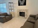 Spacious living room with fireplace and modern furniture at 4854 S Semoran Blvd # 2203, Orlando, FL 32822