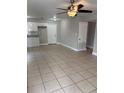 Spacious living room featuring light tile floors and ceiling fan at 5640 Chet Dr, Orlando, FL 32818